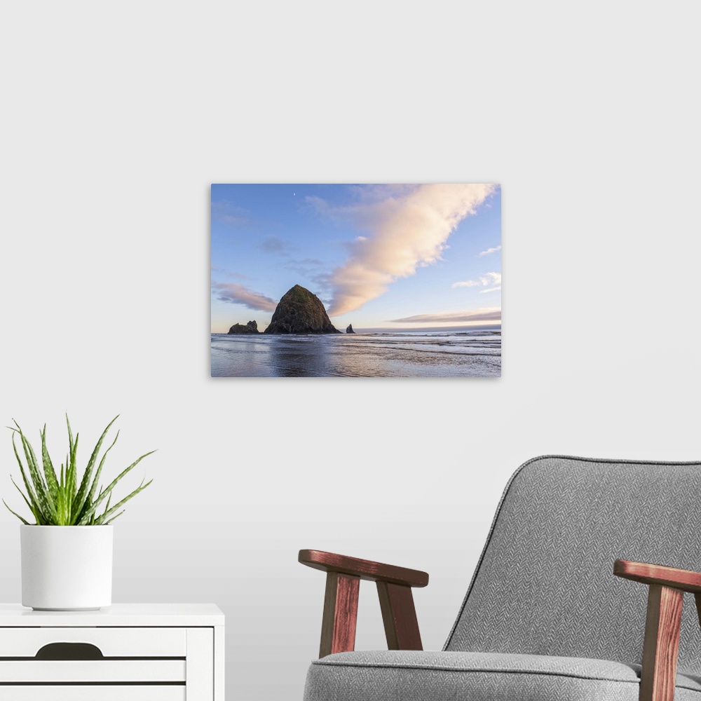 A modern room featuring Photograph of Haystack Rock at sunset with rippling waters in the foreground and the moon above.