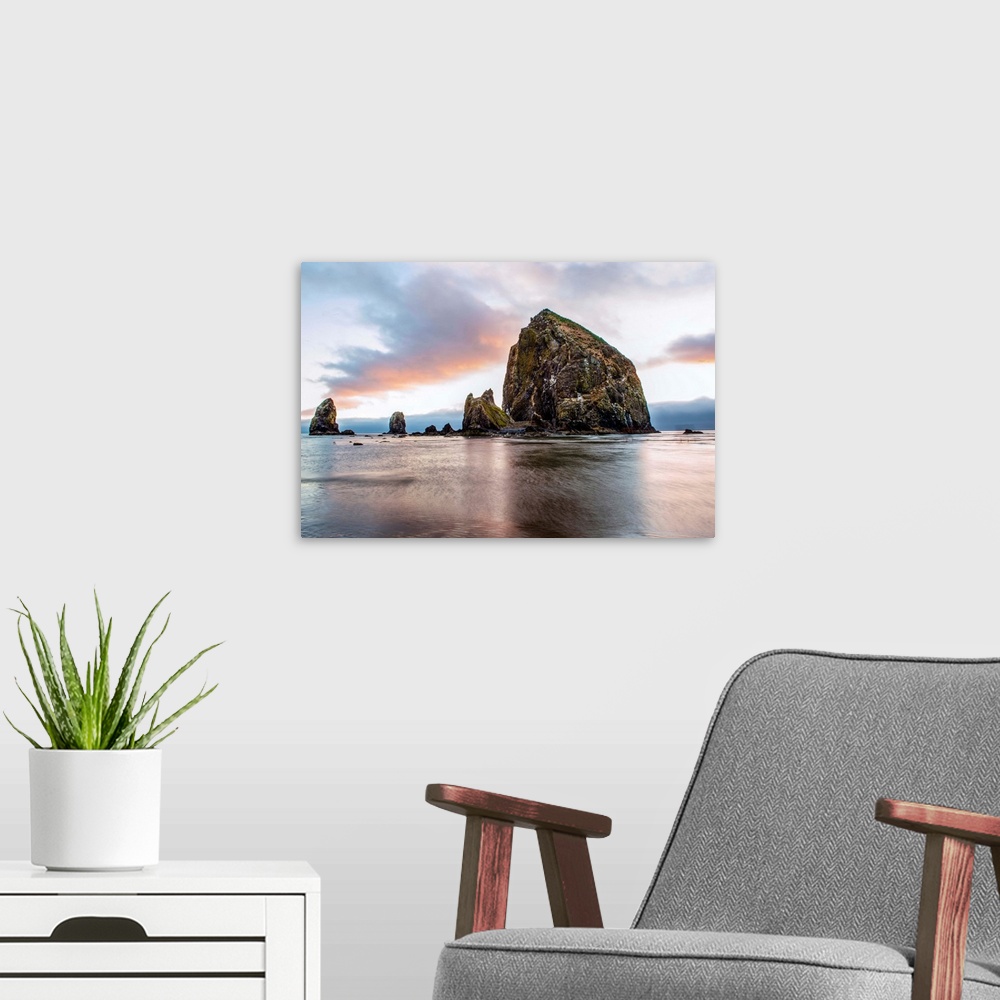 A modern room featuring View of a giant sea stack called, "Haystack Rock" at Cannon Beach in Portland, Oregon.
