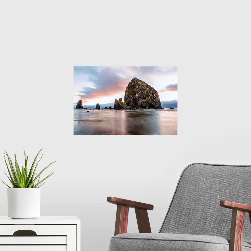A modern room featuring View of a giant sea stack called, "Haystack Rock" at Cannon Beach in Portland, Oregon.