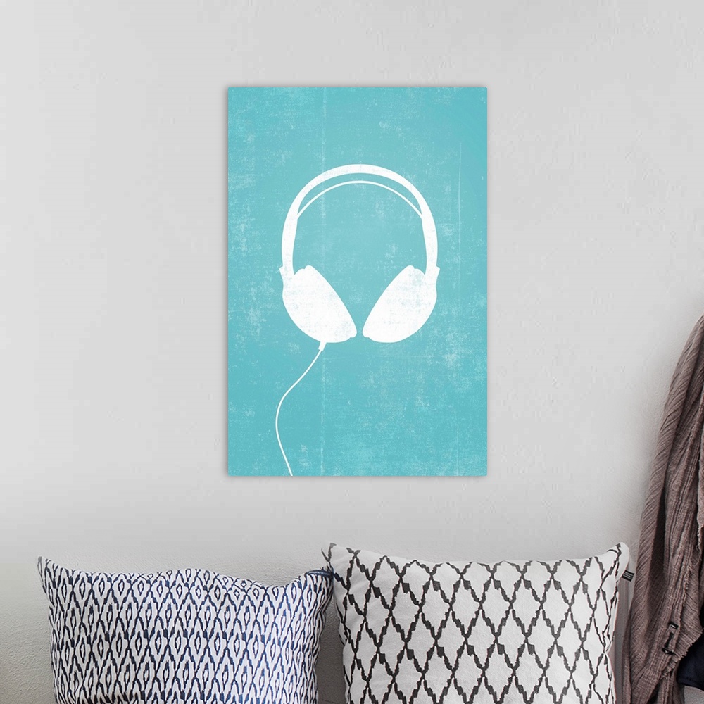 A bohemian room featuring Giant, vertical retro art of a white silhouette of a pair of headphones with a thin cord attached...