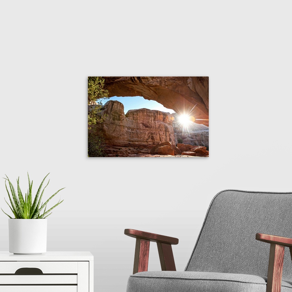 A modern room featuring The sun peeking through Hickman Bridge arch at Capitol Reef National Park in Utah.