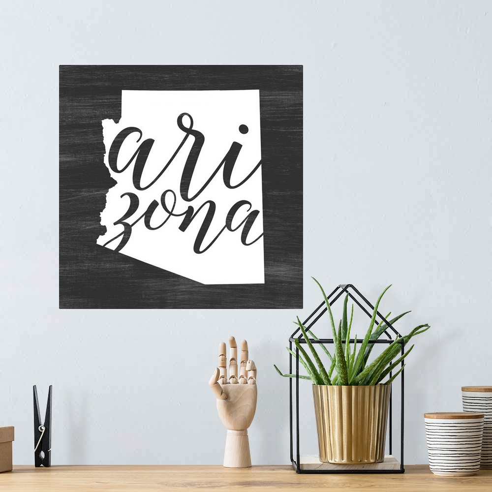 A bohemian room featuring Arizona state outline typography artwork.