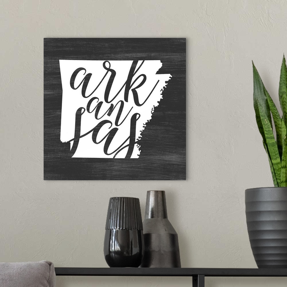 A modern room featuring Arkansas state outline typography artwork.