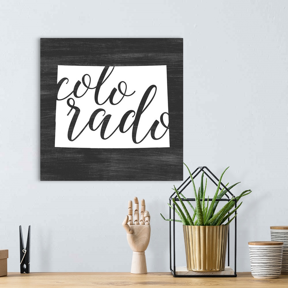 A bohemian room featuring Colorado state outline typography artwork.