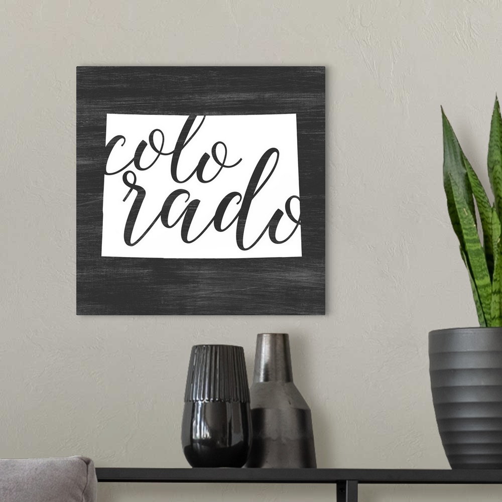 A modern room featuring Colorado state outline typography artwork.