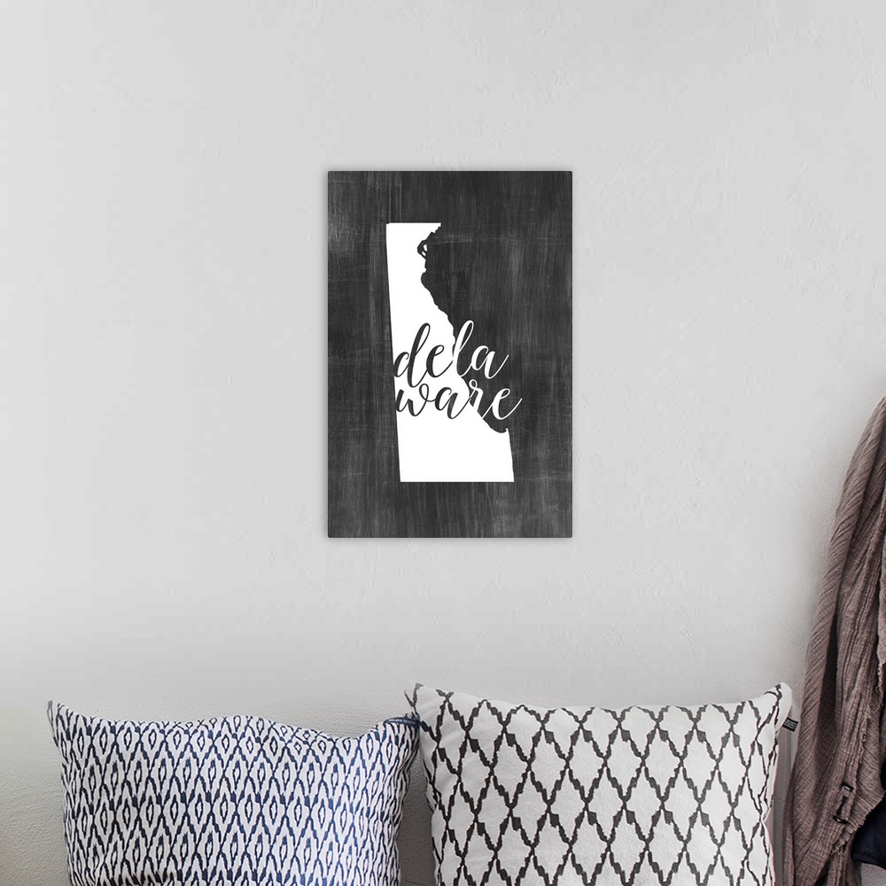 A bohemian room featuring Delaware state outline typography artwork.
