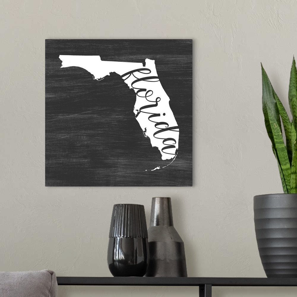 A modern room featuring Florida state outline typography artwork.