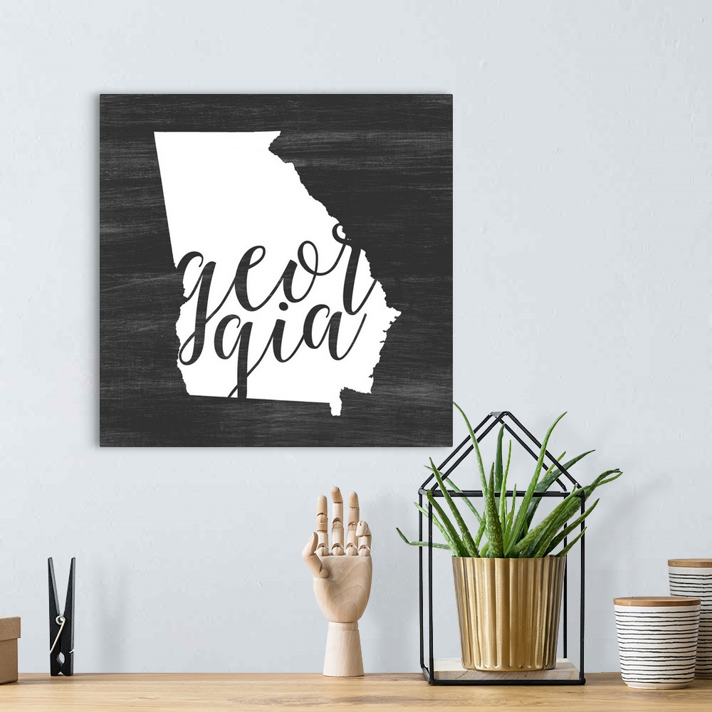 A bohemian room featuring Georgia state outline typography artwork.