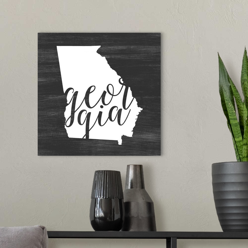 A modern room featuring Georgia state outline typography artwork.