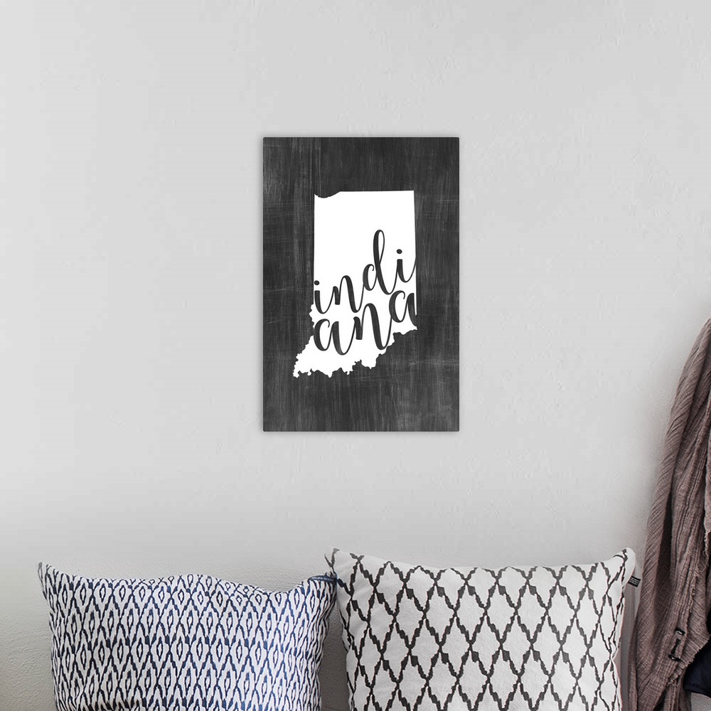 A bohemian room featuring Indiana state outline typography artwork.