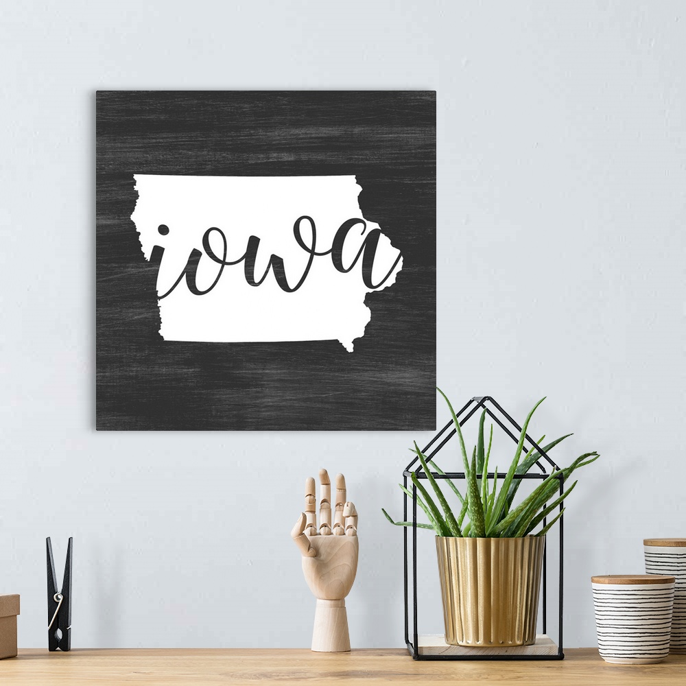 A bohemian room featuring Iowa state outline typography artwork.