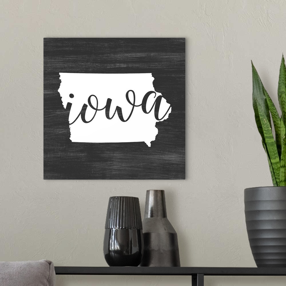 A modern room featuring Iowa state outline typography artwork.