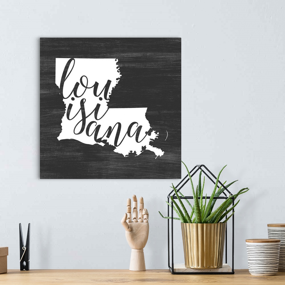 A bohemian room featuring Louisiana state outline typography artwork.