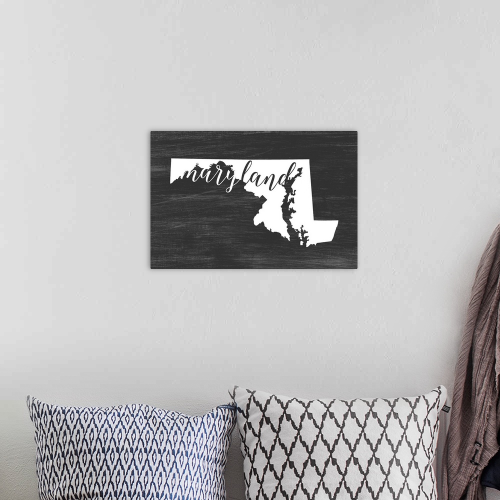 A bohemian room featuring Maryland state outline typography artwork.