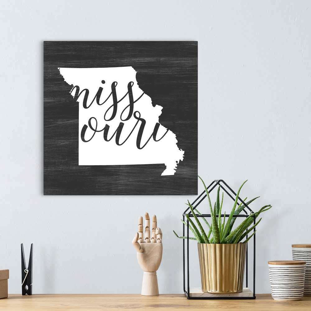 A bohemian room featuring Missouri state outline typography artwork.