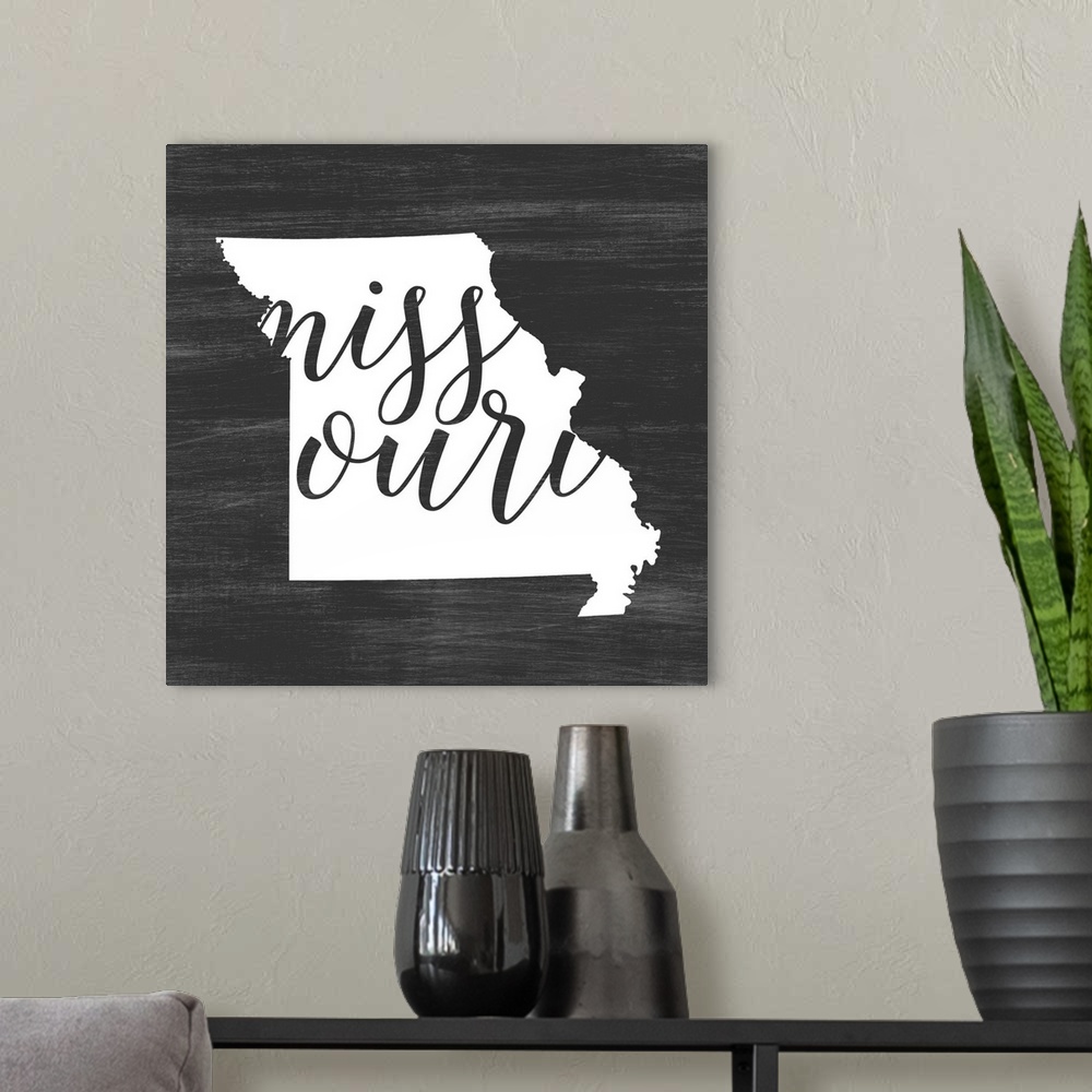 A modern room featuring Missouri state outline typography artwork.