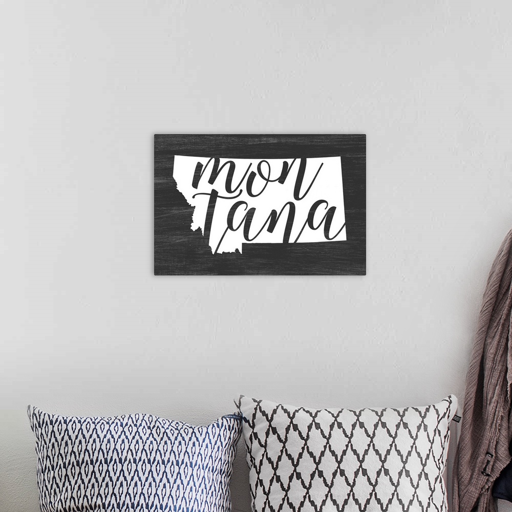A bohemian room featuring Montana state outline typography artwork.