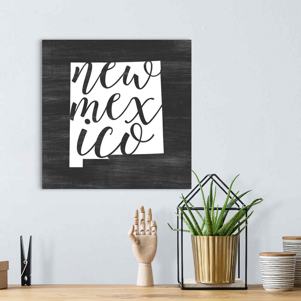 A bohemian room featuring New Mexico state outline typography artwork.