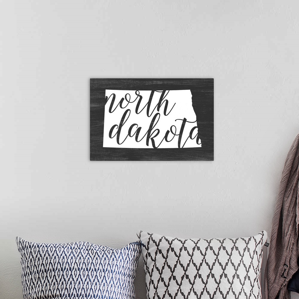 A bohemian room featuring North Dakota state outline typography artwork.
