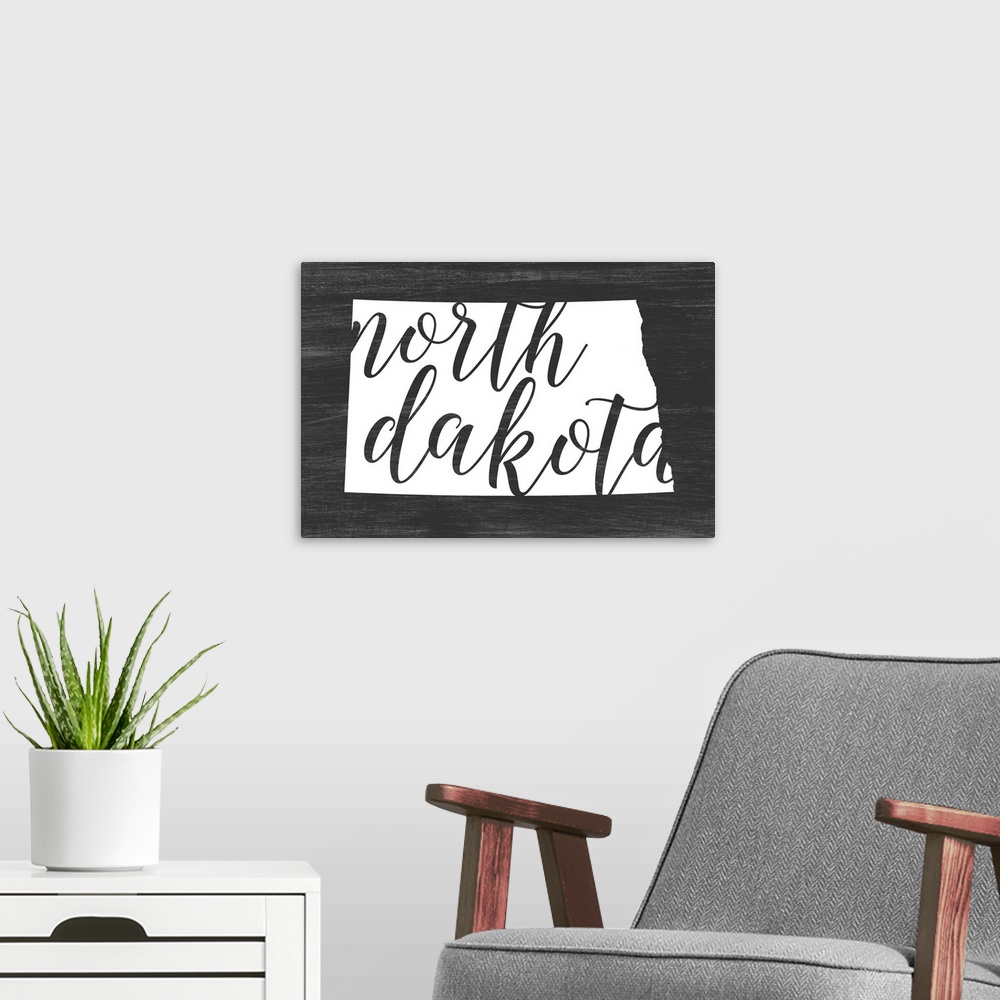 A modern room featuring North Dakota state outline typography artwork.
