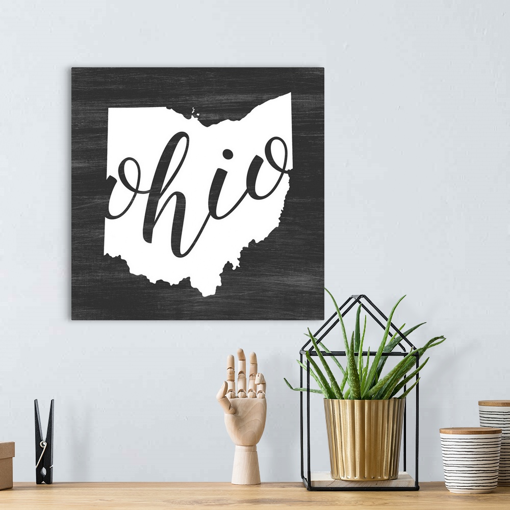 A bohemian room featuring Ohio state outline typography artwork.
