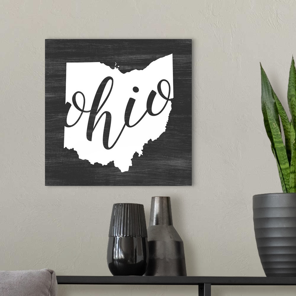A modern room featuring Ohio state outline typography artwork.