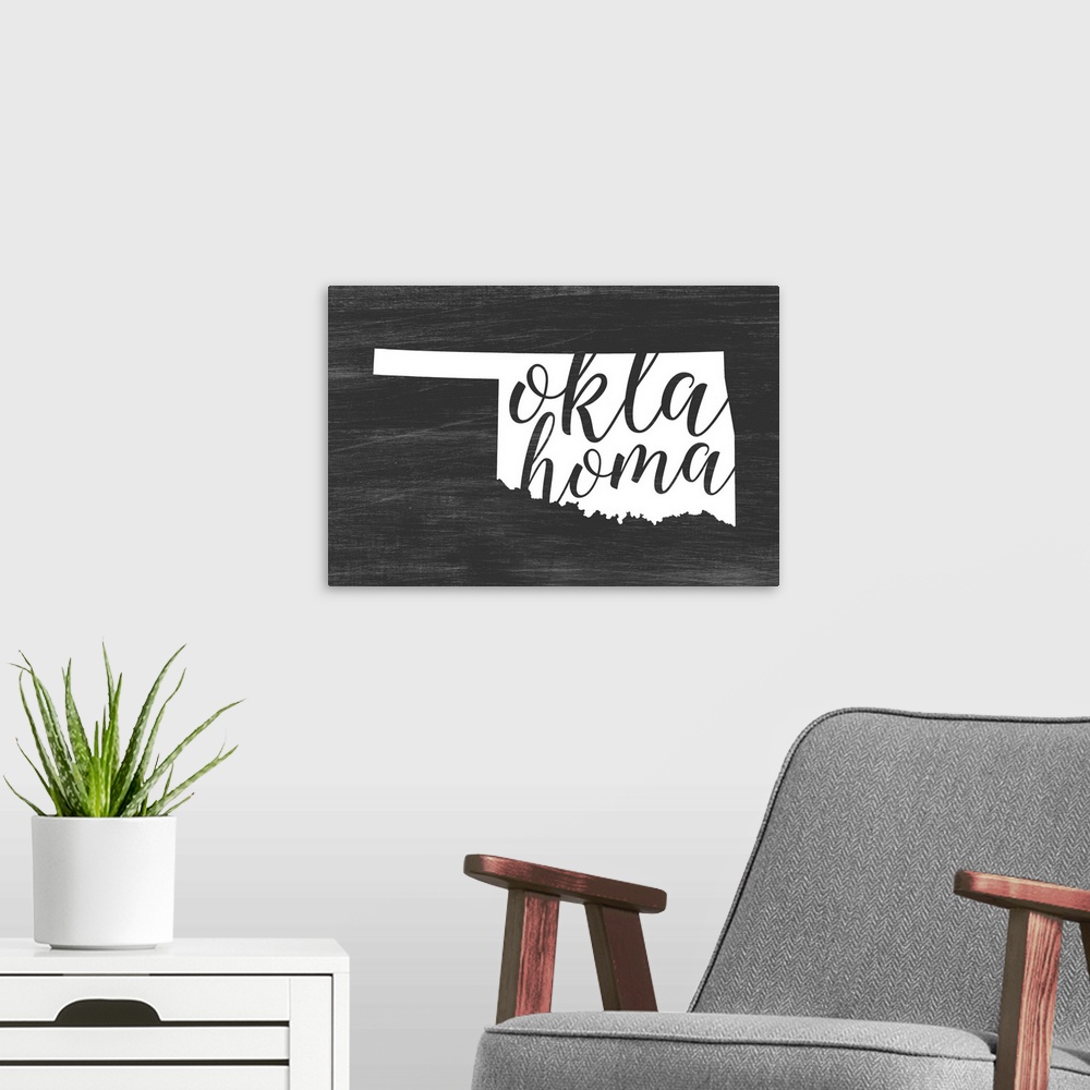 A modern room featuring Oklahoma state outline typography artwork.
