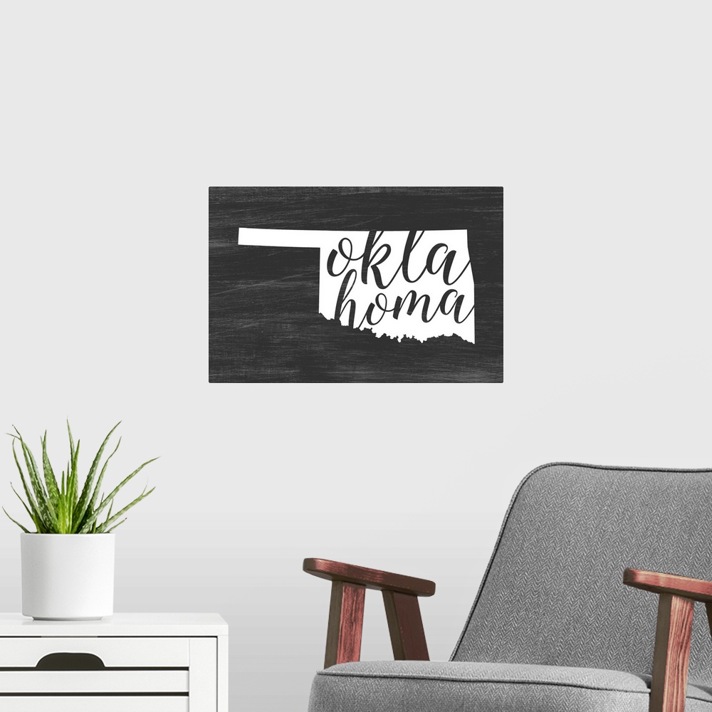 A modern room featuring Oklahoma state outline typography artwork.