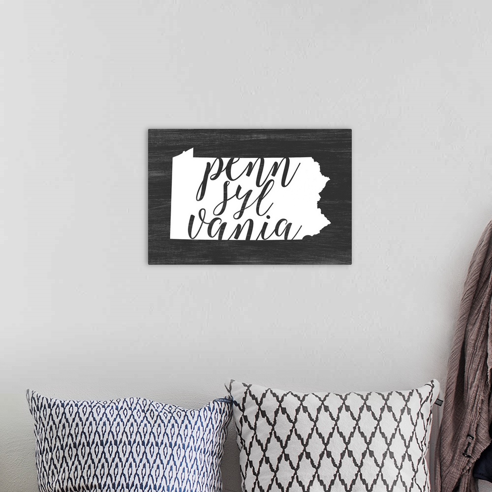 A bohemian room featuring Pennsylvania state outline typography artwork.