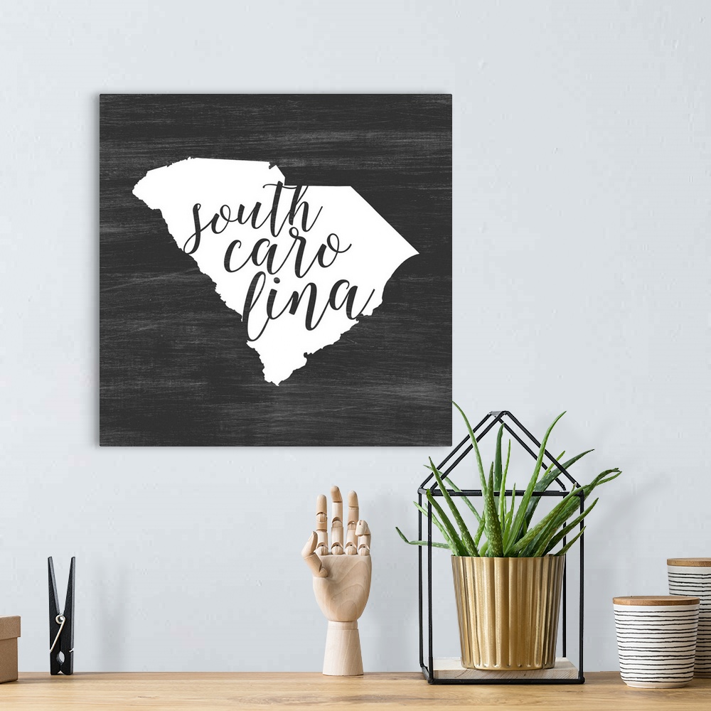 A bohemian room featuring South Carolina state outline typography artwork.