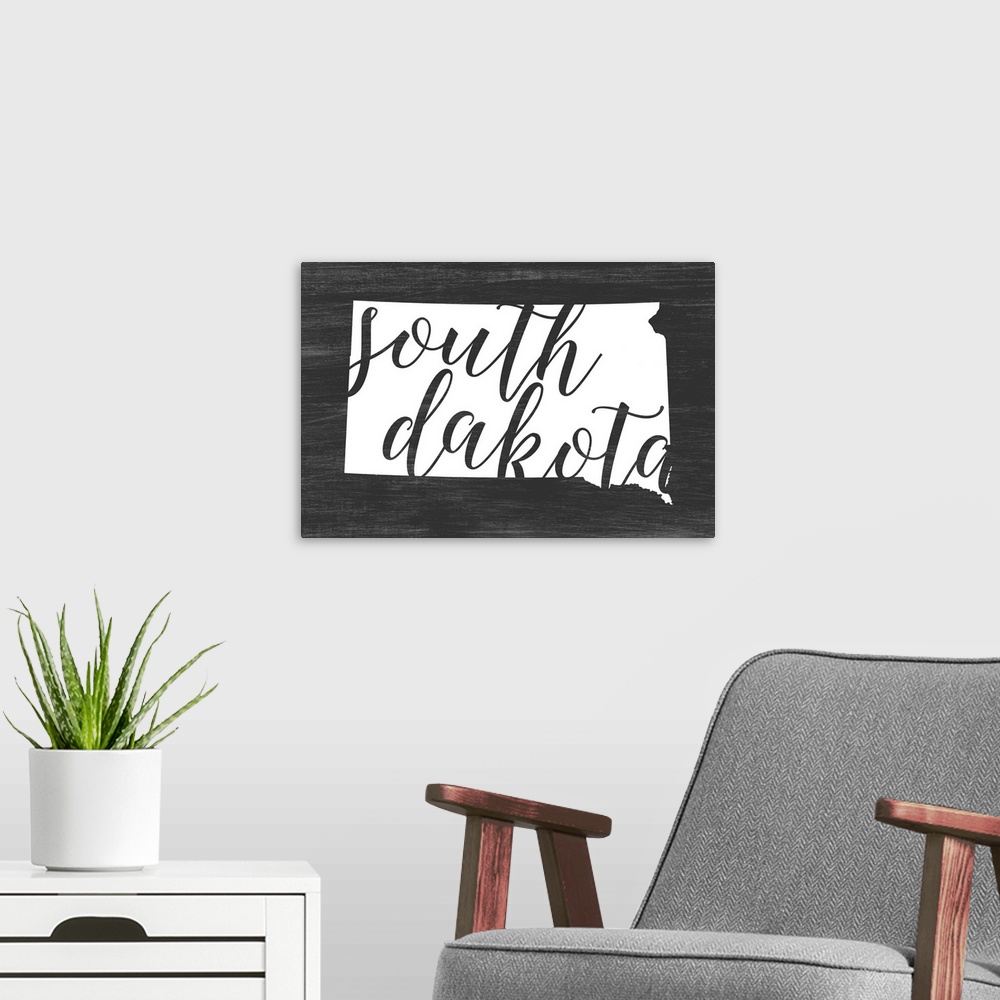 A modern room featuring South Dakota state outline typography artwork.