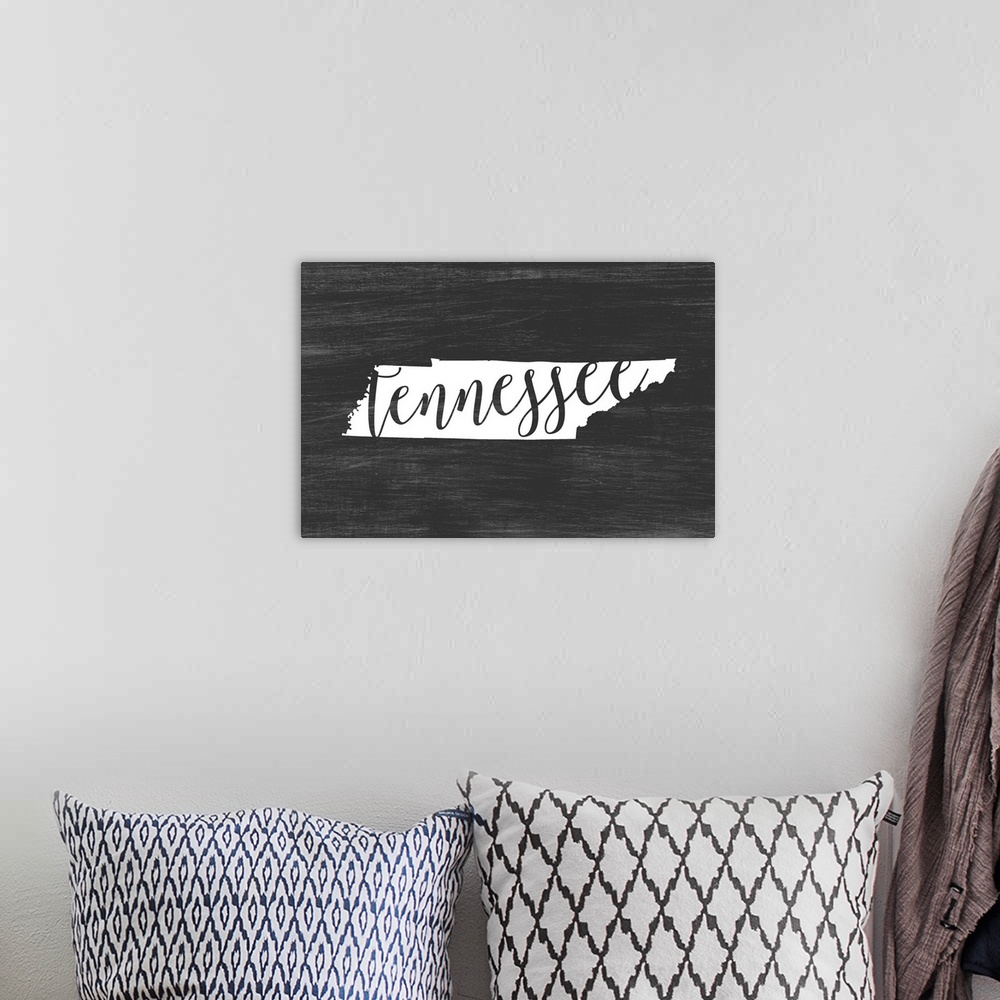 A bohemian room featuring Tennessee state outline typography artwork.