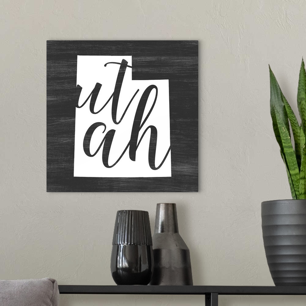 A modern room featuring Utah state outline typography artwork.