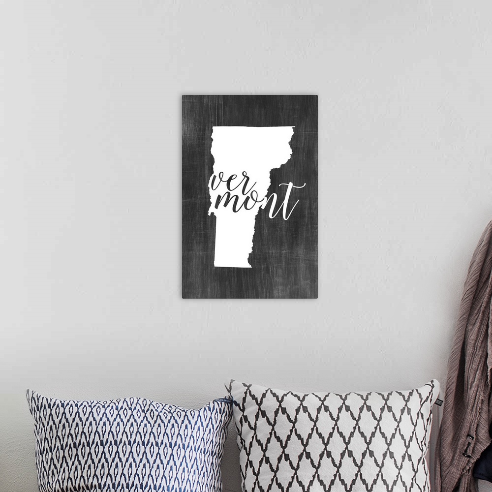 A bohemian room featuring Vermont state outline typography artwork.