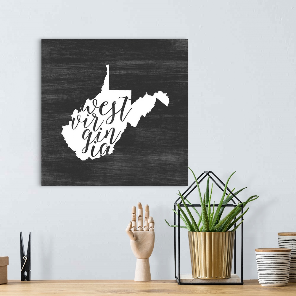 A bohemian room featuring West Virginia state outline typography artwork.