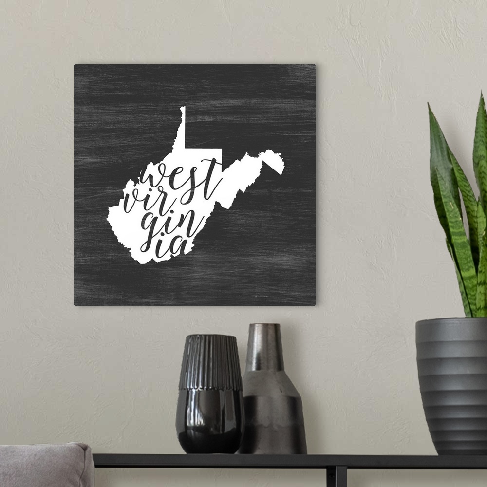 A modern room featuring West Virginia state outline typography artwork.