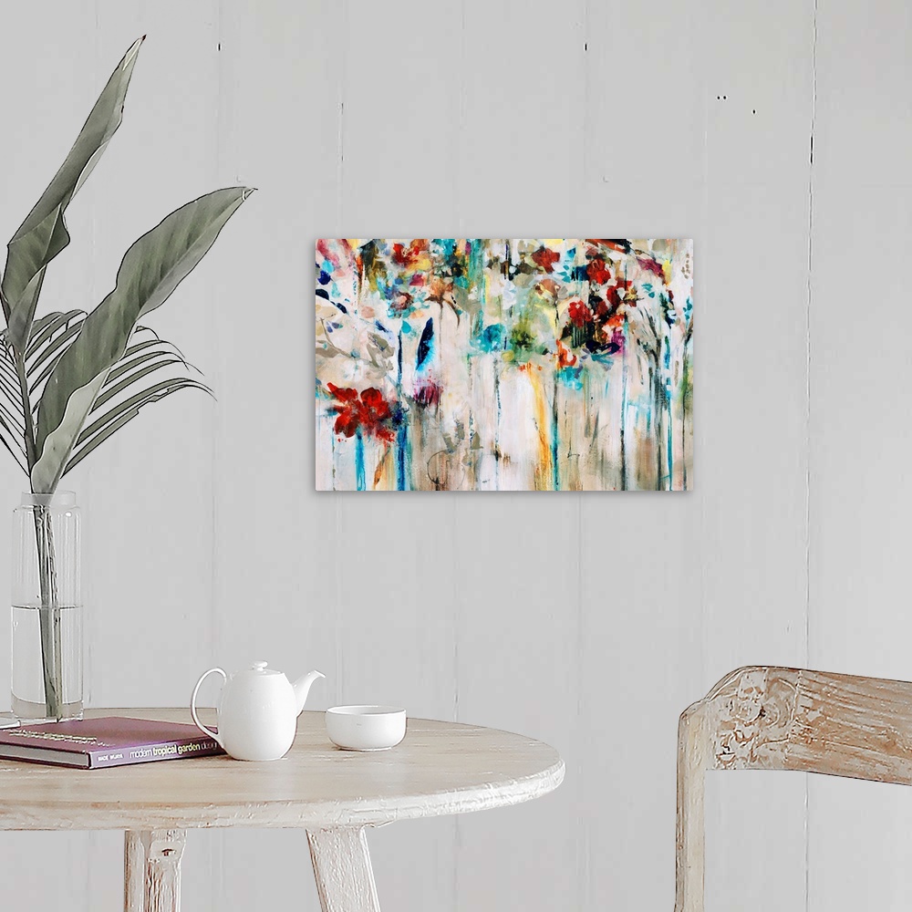 A farmhouse room featuring Abstracted painting of flowers done in brilliant colors set against a neutral background.