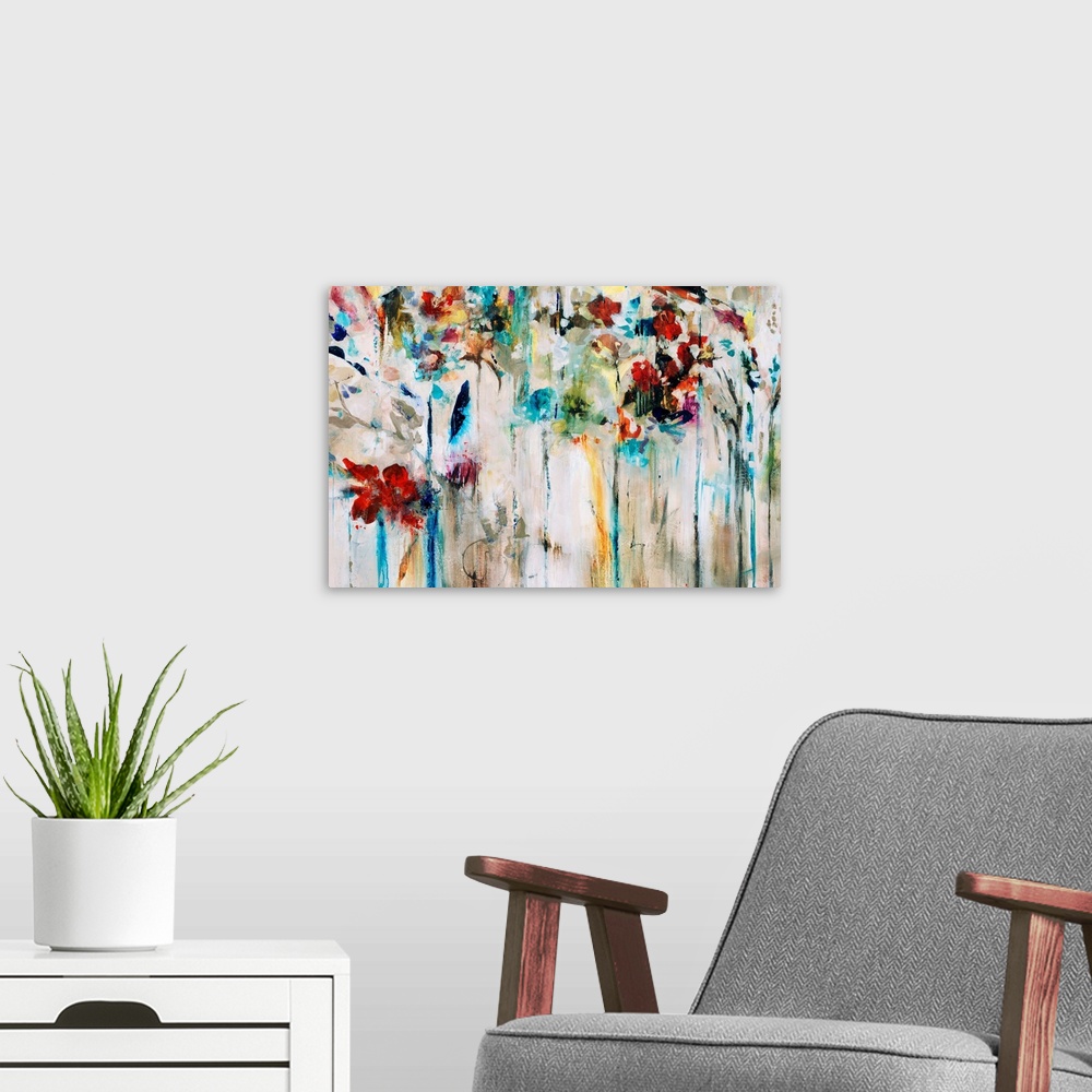 A modern room featuring Abstracted painting of flowers done in brilliant colors set against a neutral background.