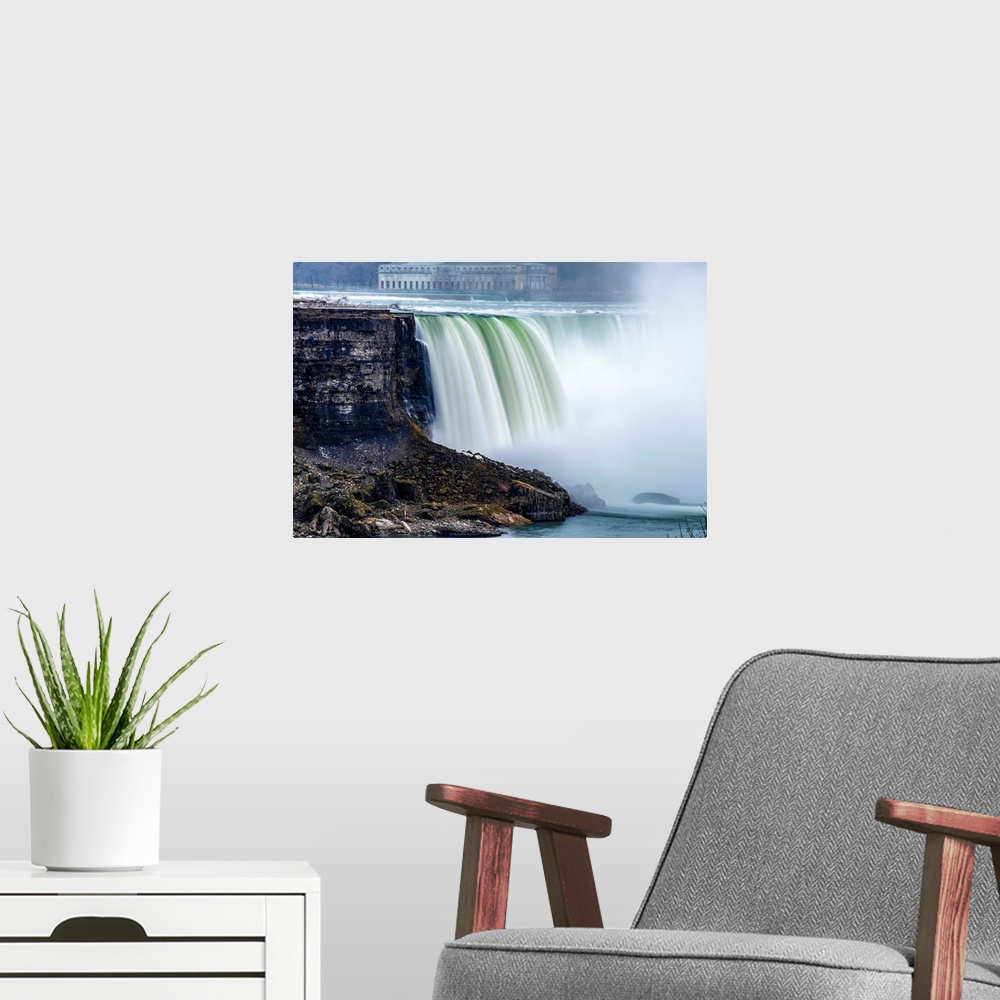 A modern room featuring View of Horseshoe Falls at Niagara Falls with former Toronto power generating station in the back...