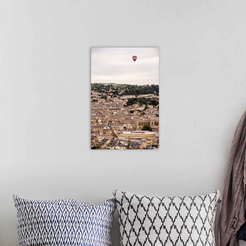 A bohemian room featuring Photograph of a red and white hot air balloon flying over the city of Bath in England, UK.