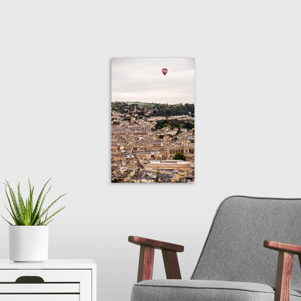 A modern room featuring Photograph of a red and white hot air balloon flying over the city of Bath in England, UK.
