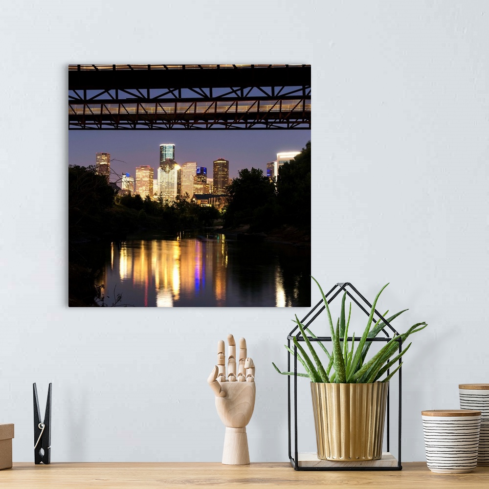 A bohemian room featuring Square photograph of the Houston TX skyline at night reflecting into the Buffalo Bayou with the R...