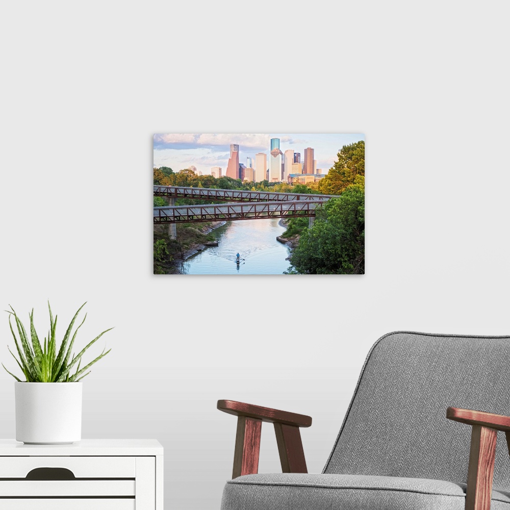 A modern room featuring Photograph of the Houston TX skyline in the distance with the  Rosemont pedestrian bridge in the ...