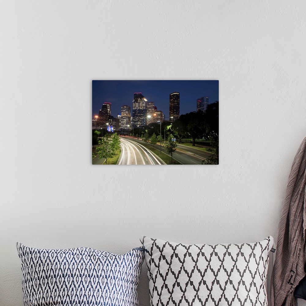 A bohemian room featuring Long exposure photograph of the Houston TX skyline at night from the highway with red and white l...
