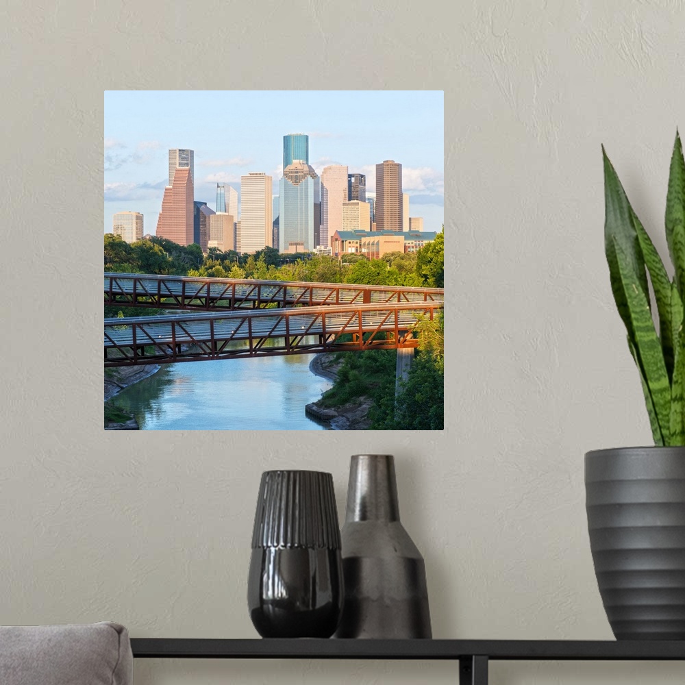 A modern room featuring Square photograph of the Houston TX skyline in the distance with the  Rosemont pedestrian bridge ...