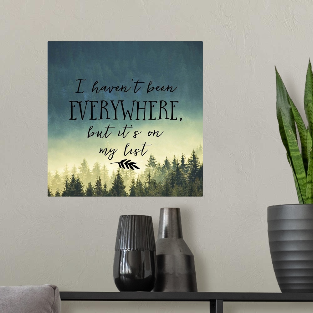 A modern room featuring Handwritten message about adventure and travel, over an image of a misty pine forest.