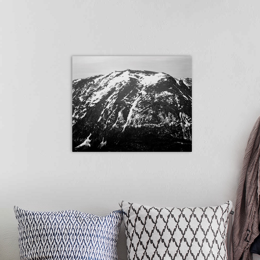 A bohemian room featuring In Rocky Mountain National Park, full view of barren mountain side with snow.