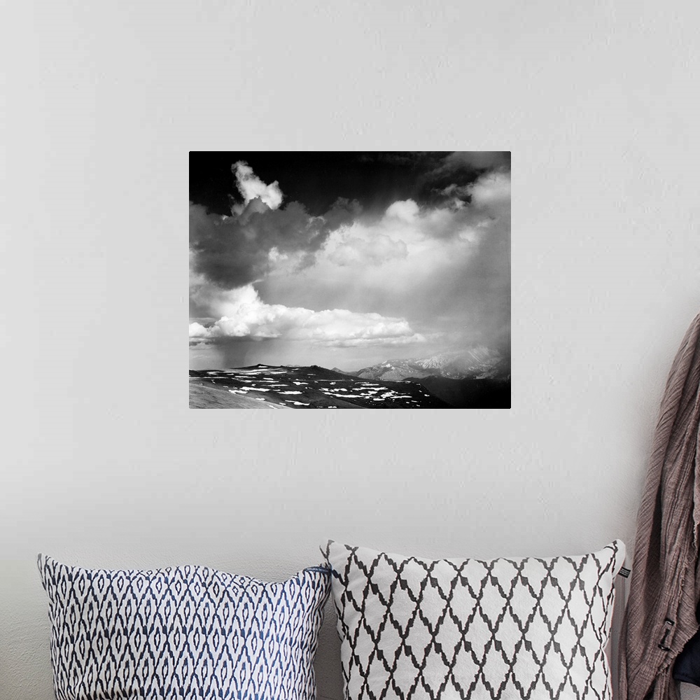A bohemian room featuring In Rocky Mountain National Park, mountain tops, low horizon, dramatic clouded sky.