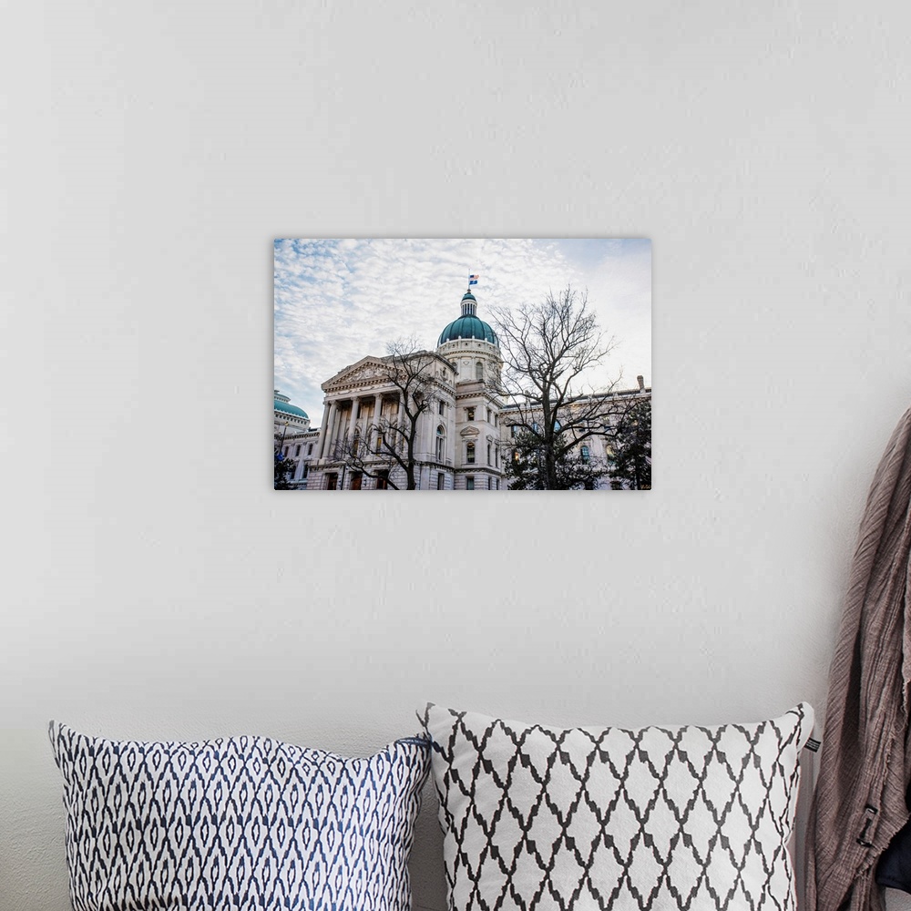 A bohemian room featuring Photo of the Indiana State House under puffy clouds.
