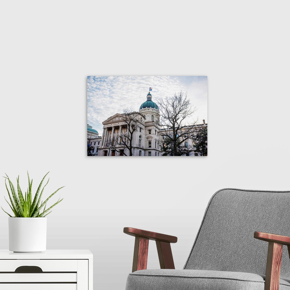 A modern room featuring Photo of the Indiana State House under puffy clouds.